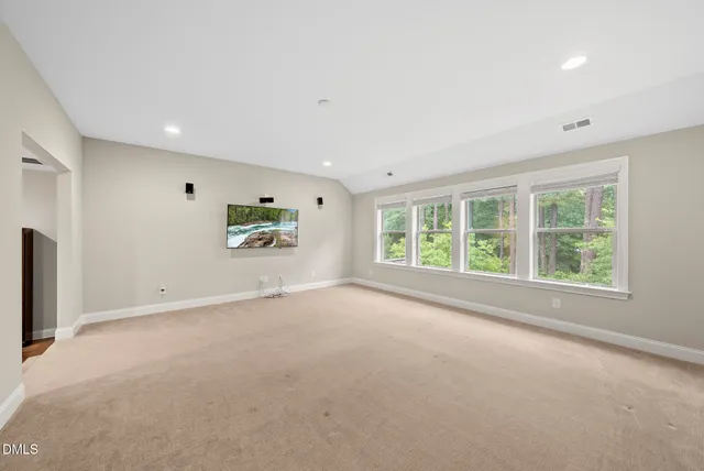 a view of room with window and wooden floor