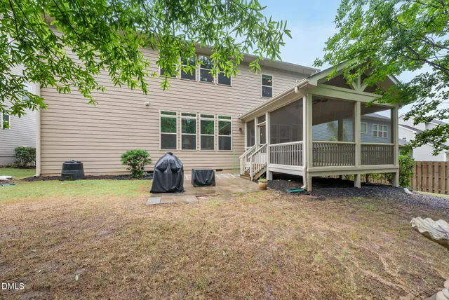 a utility room with dryer washer and a view of living room