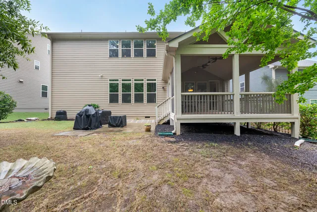a view of a patio with a table chairs and wooden floor