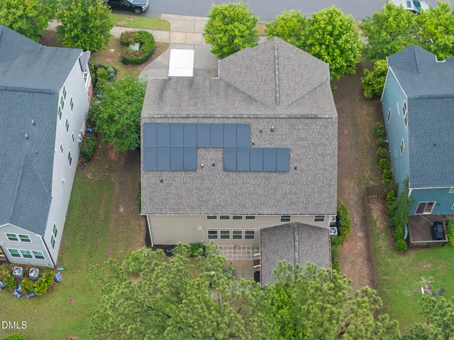 an aerial view of a house with a yard and lake view