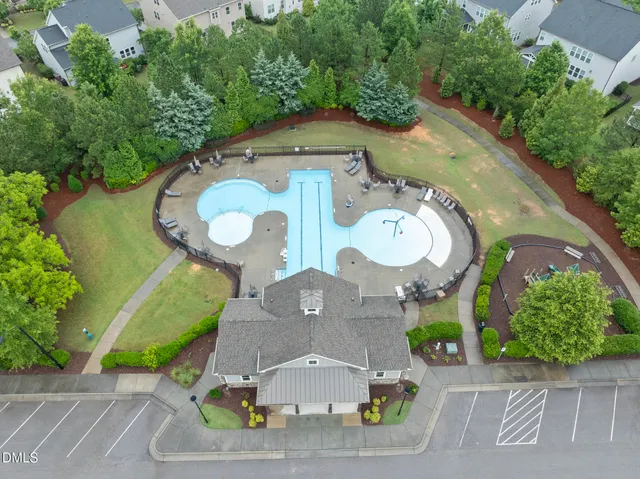 an aerial view of a house with yard swimming pool and outdoor seating