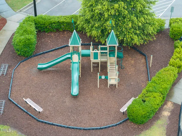 an aerial view of a house with outdoor space and tennis court