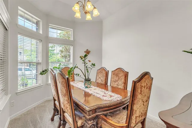 a dining room with furniture a rug and a chandelier