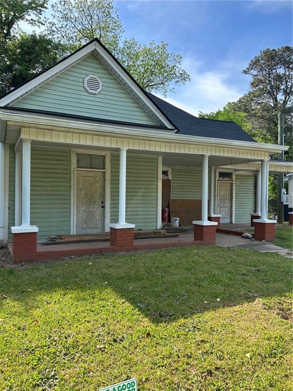 a front view of a house with a garden and porch