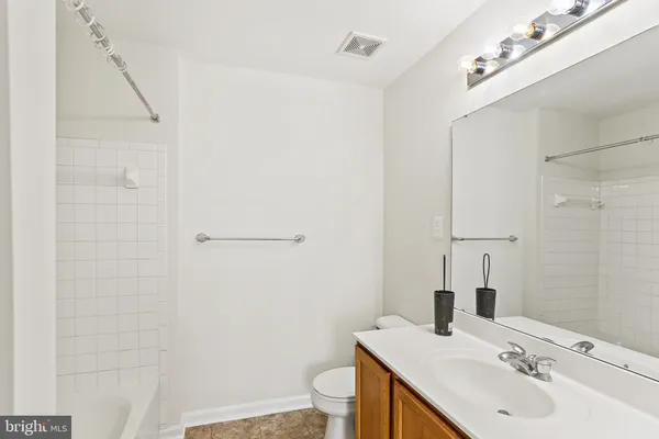 a bathroom with a sink and mirror with toilet