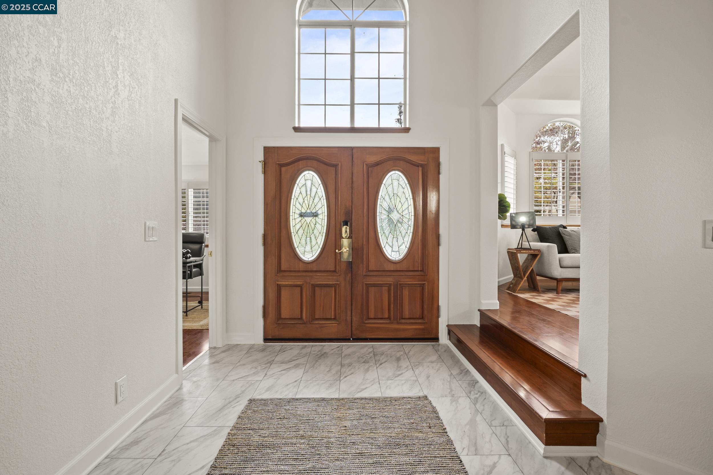 419 Clark Drive Vallejo, CA 94591 - Photo 3 of 39 a view of a hallway with entryway wooden floor and front door