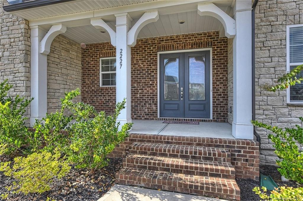 2227 Watermark Point Place Fort Mill, SC 29708 - Photo 2 of 43 a front view of a house with a garden