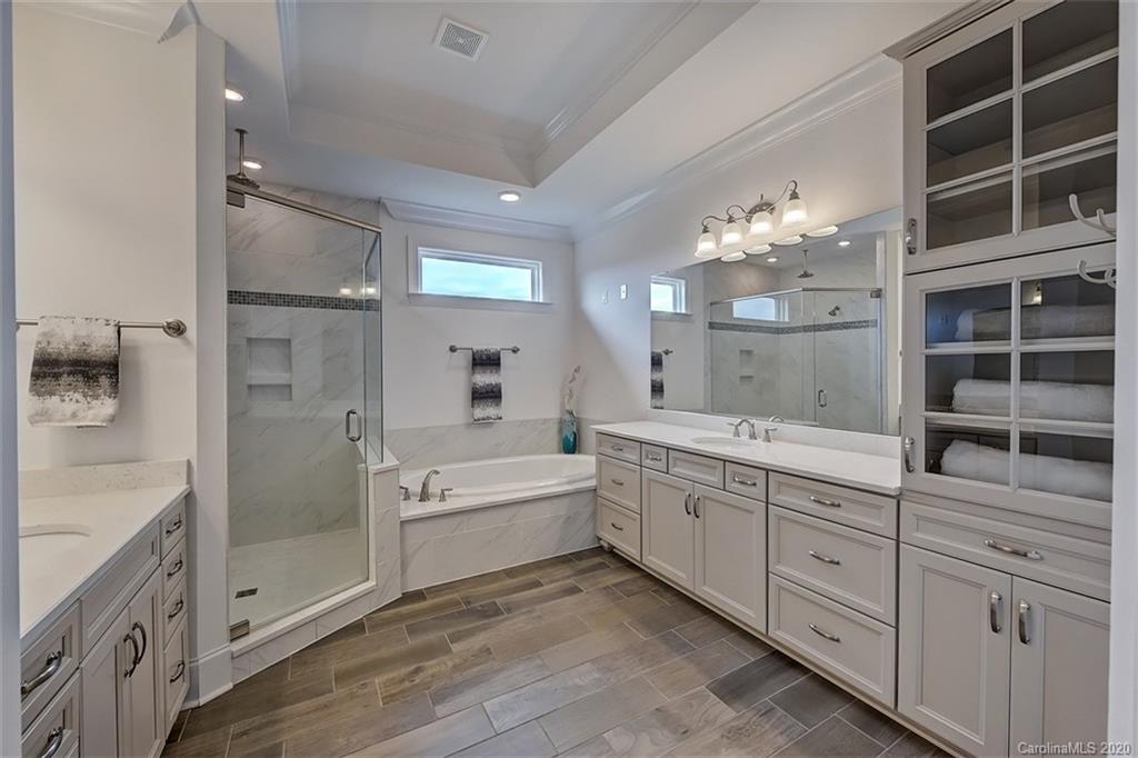 2227 Watermark Point Place Fort Mill, SC 29708 - Photo 25 of 43 a spacious bathroom with a double vanity sink a large mirror and shower