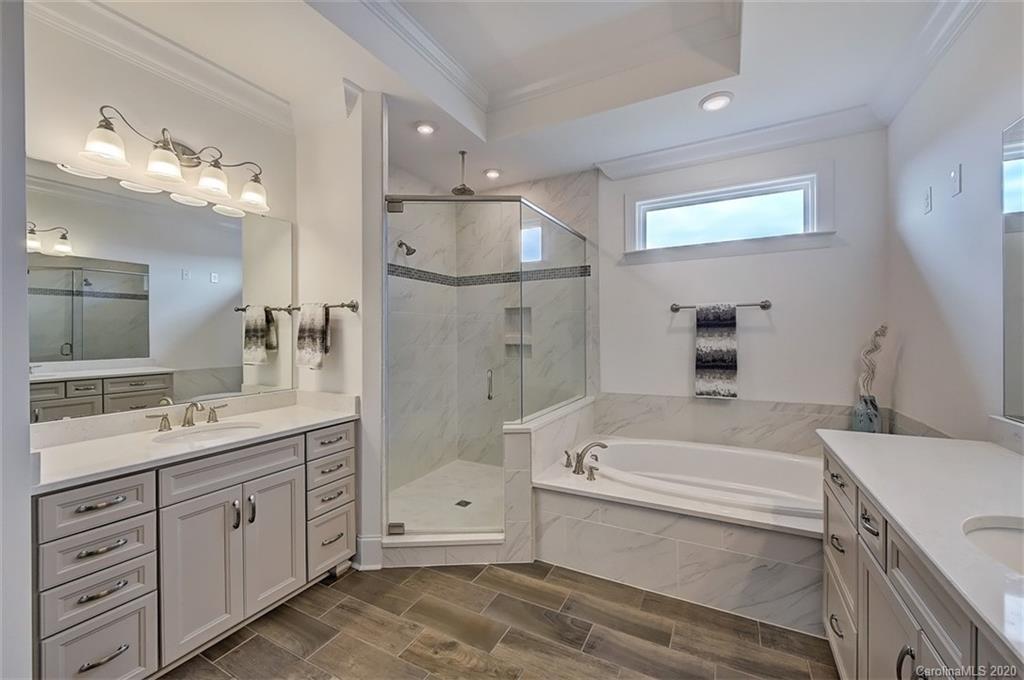 2227 Watermark Point Place Fort Mill, SC 29708 - Photo 26 of 43 a bathroom with a tub a sink double vanity and a mirror