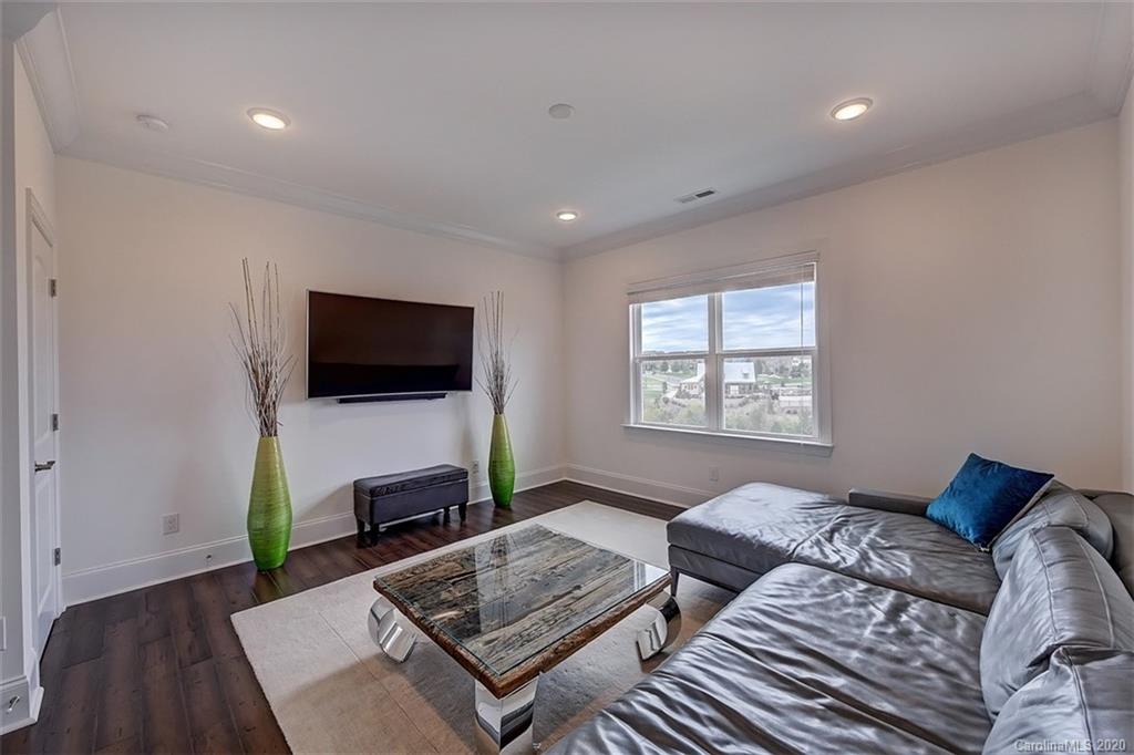 2227 Watermark Point Place Fort Mill, SC 29708 - Photo 28 of 43 a bedroom with furniture and a flat screen tv