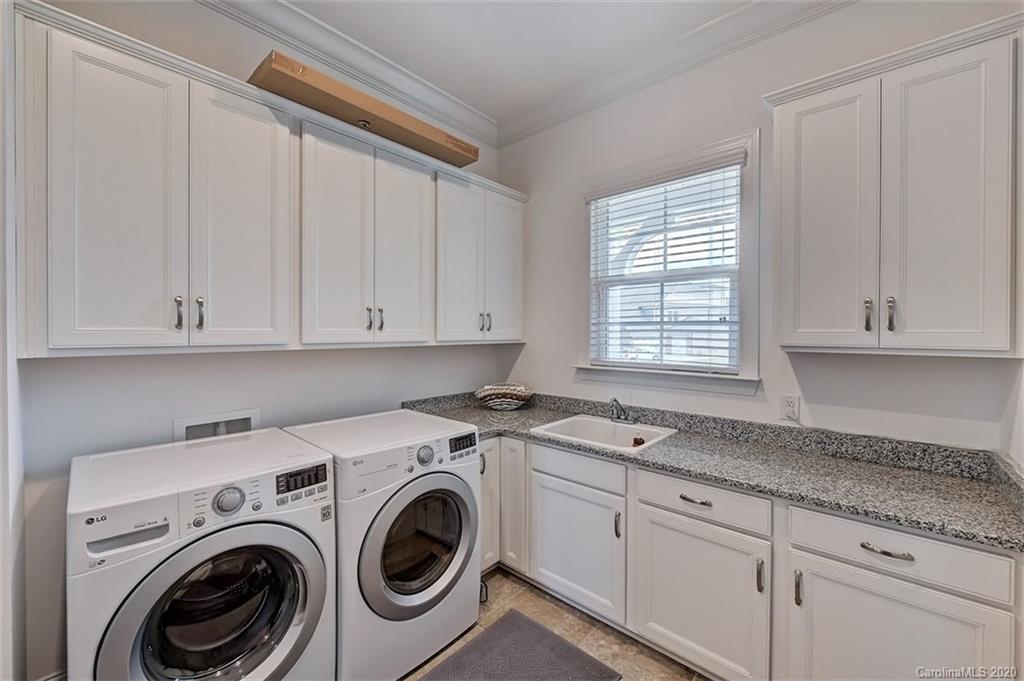 2227 Watermark Point Place Fort Mill, SC 29708 - Photo 29 of 43 a utility room with granite countertop cabinets washer and dryer