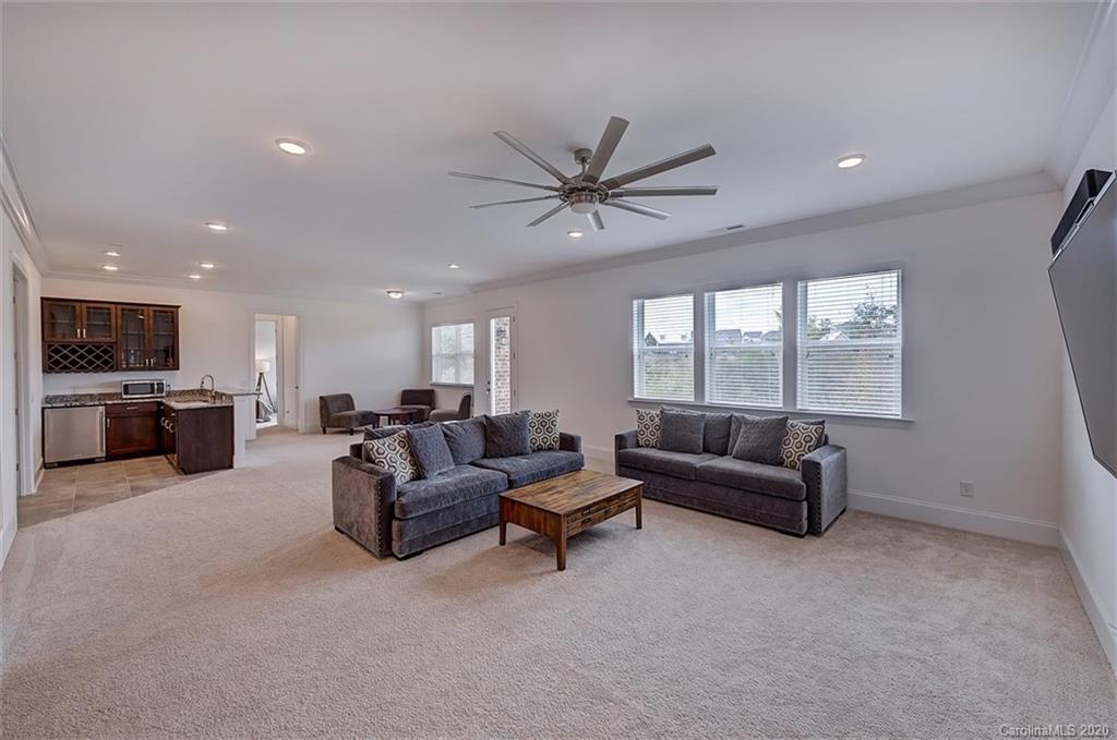 2227 Watermark Point Place Fort Mill, SC 29708 - Photo 32 of 43 a living room with furniture and a large window