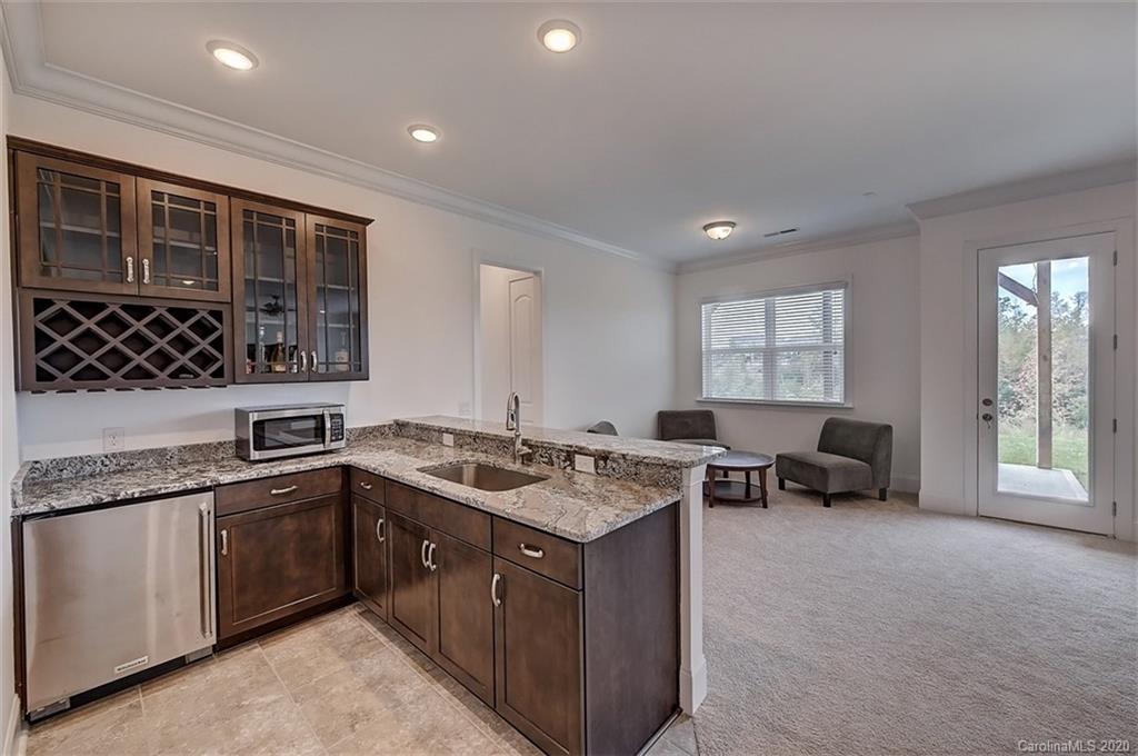 2227 Watermark Point Place Fort Mill, SC 29708 - Photo 34 of 43 a kitchen that has a sink and a stove in it