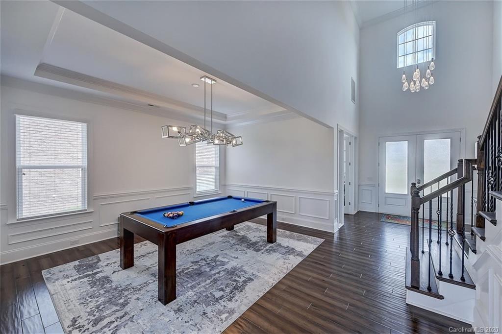 2227 Watermark Point Place Fort Mill, SC 29708 - Photo 7 of 43 a room with wooden floor pool table and windows