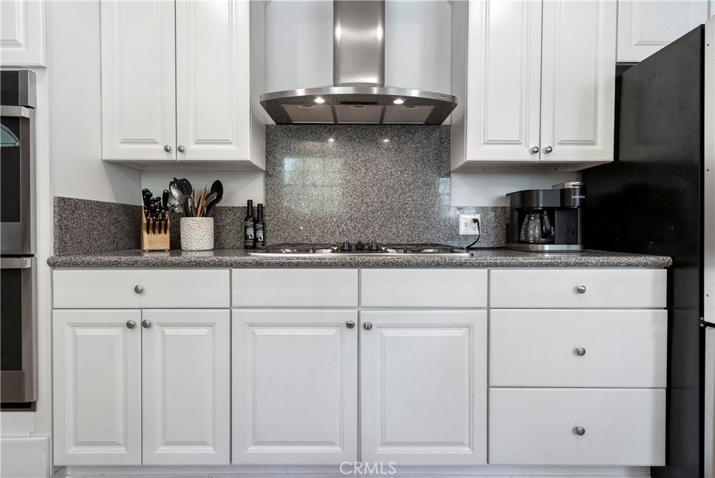 5407 Telefair Way Riverside, CA 92506 - Photo 11 of 35 a kitchen with white cabinets and a sink