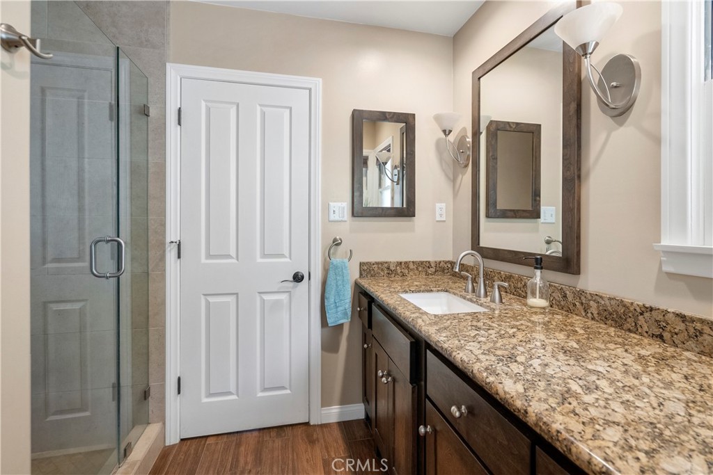 5407 Telefair Way Riverside, CA 92506 - Photo 16 of 35 a bathroom with a granite countertop sink and a mirror