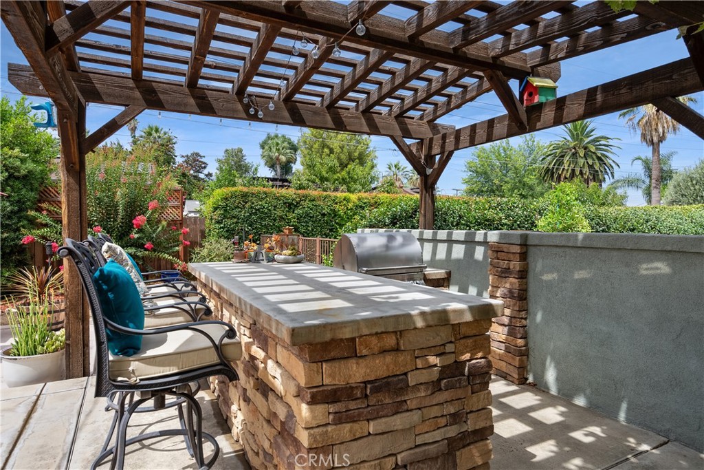 5407 Telefair Way Riverside, CA 92506 - Photo 28 of 35 a view of a patio with table and chairs under an umbrella