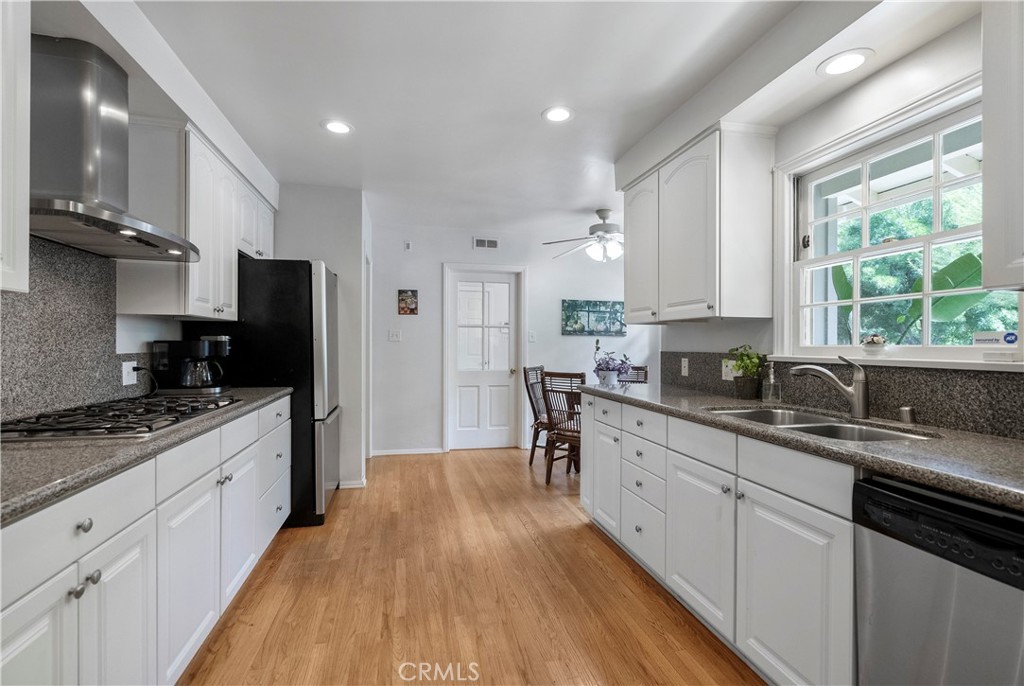 5407 Telefair Way Riverside, CA 92506 - Photo 8 of 35 a large kitchen with stainless steel appliances granite countertop a lot of counter space and wooden floors