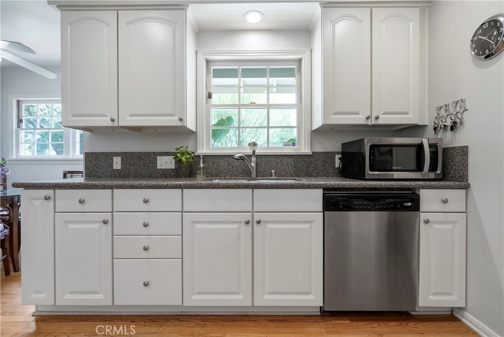 5407 Telefair Way Riverside, CA 92506 - Photo 9 of 35 a kitchen with stainless steel appliances granite countertop a sink a stove and a microwave
