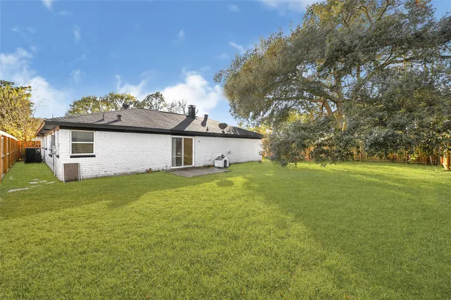 a front view of house with yard and trees