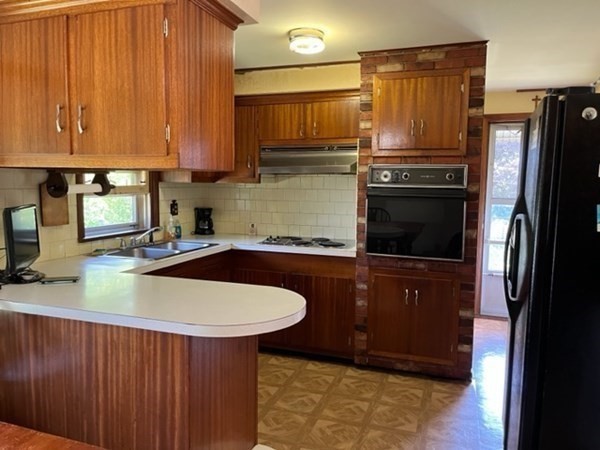 271 Bailey Street Fall River, MA 02724 - Photo 8 of 10 a kitchen with stainless steel appliances granite countertop a sink refrigerator and microwave