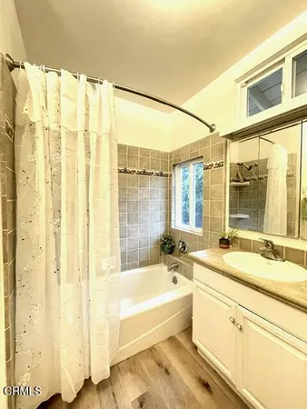 a bathroom with a bathtub and a sink