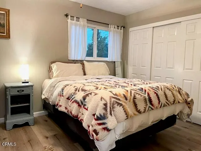 a bed sitting in a bedroom next to a window