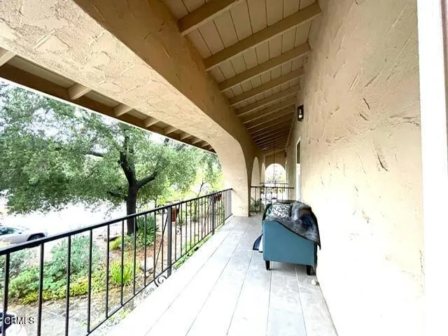 a balcony with wooden floor