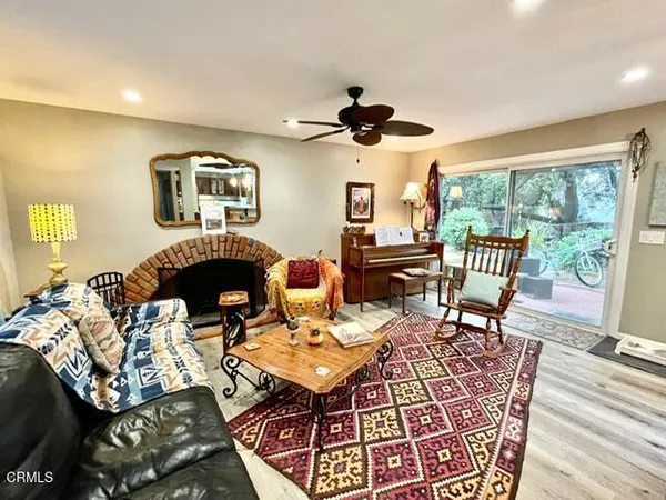 a living room with furniture a fireplace and a flat screen tv