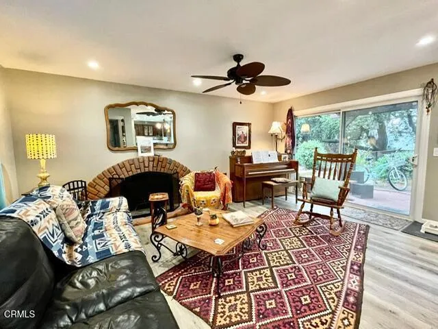 a living room with furniture a fireplace and a flat screen tv