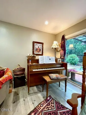 a living room with furniture and a piano