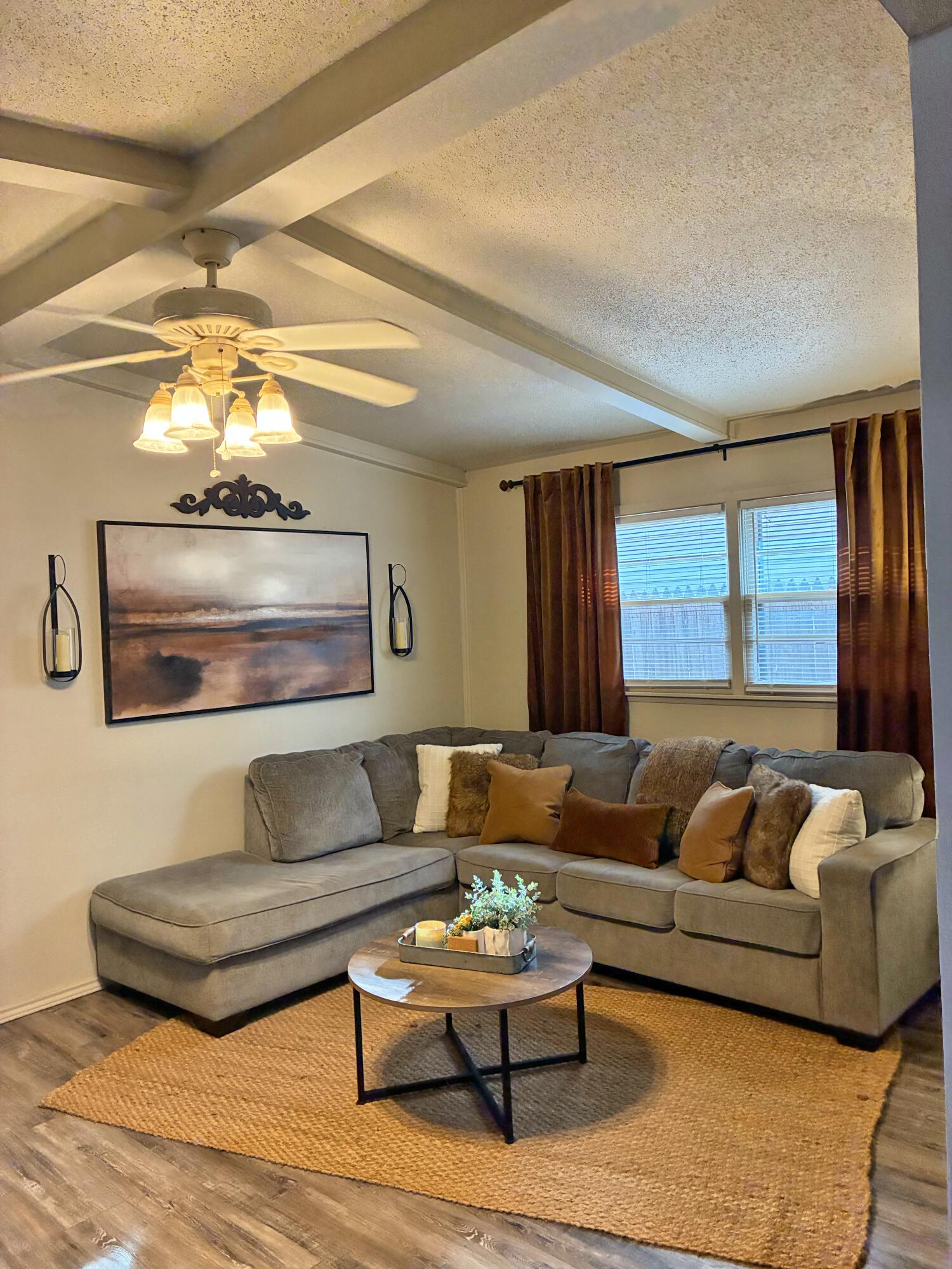 4203 17th Street Lubbock, TX 79416 - Photo 4 of 15 a living room with furniture and a large window