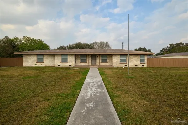 a front view of a house with yard