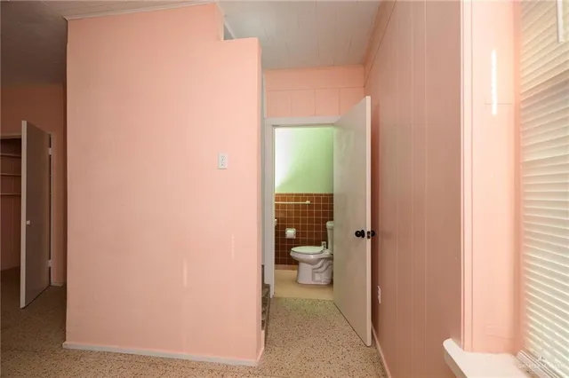 a bathroom with a toilet and a shower