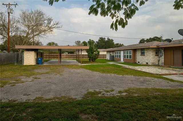 a view of house with yard and sitting area