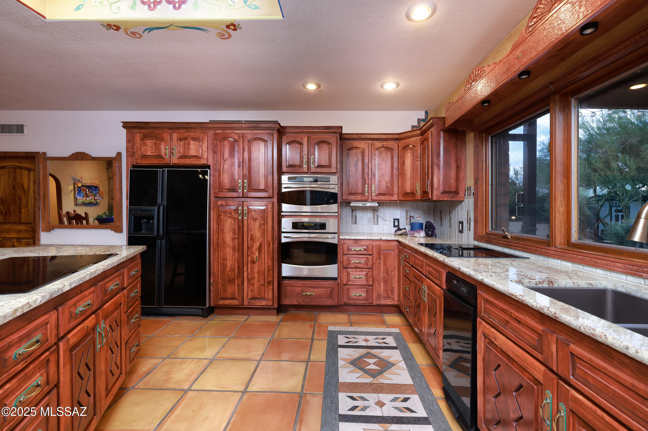 925 North Rancho Del Jefe Loop Tucson, AZ 85748 - Photo 18 of 52 a kitchen with stainless steel appliances granite countertop a refrigerator and a sink