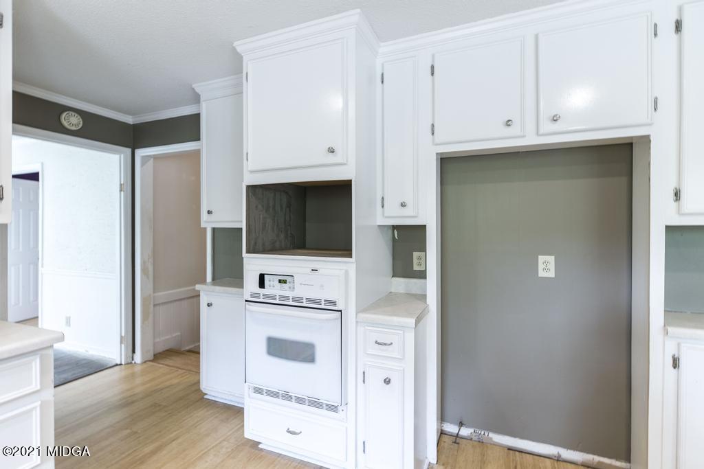 225 Beacon Hill Road Macon, GA 31210 - Photo 11 of 29 a view of cabinets with wooden floor and electronic appliances
