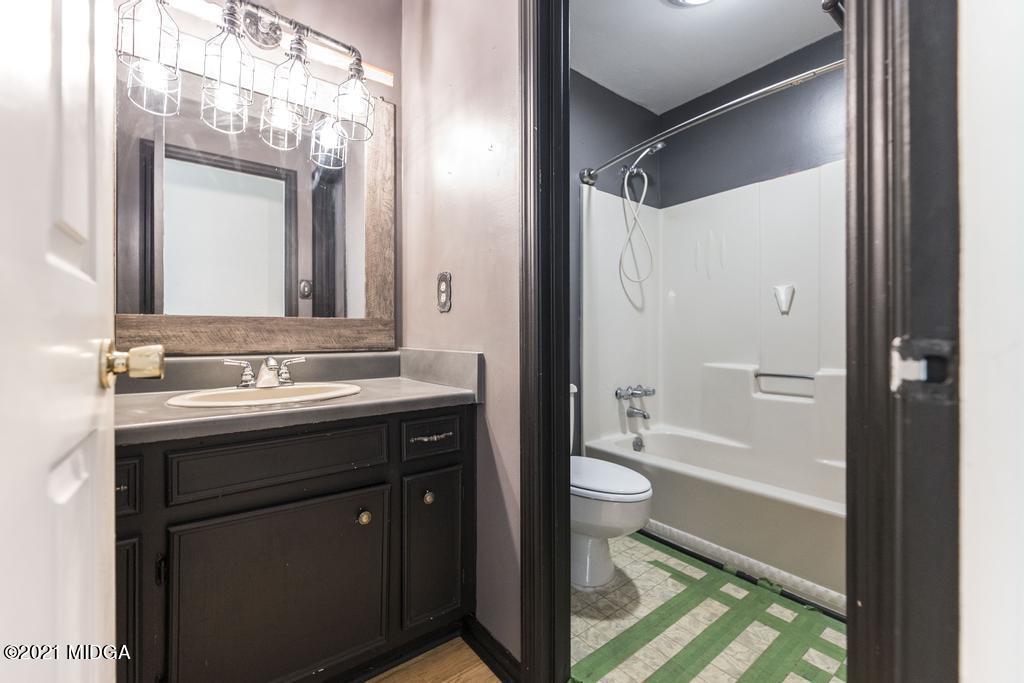 225 Beacon Hill Road Macon, GA 31210 - Photo 17 of 29 a bathroom with a granite countertop sink toilet and shower
