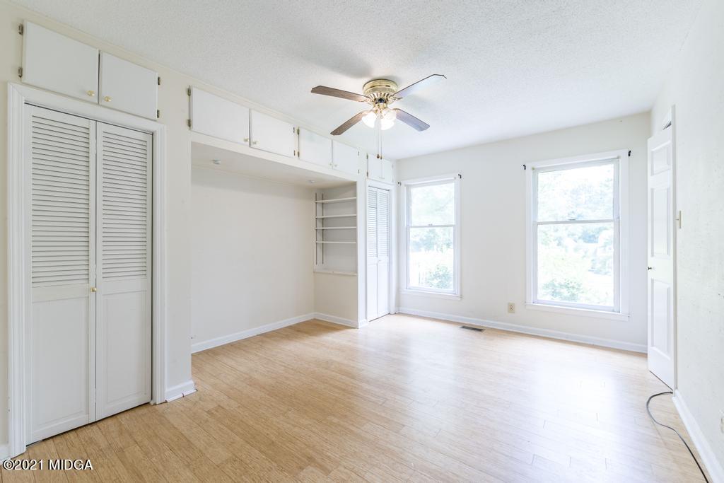 225 Beacon Hill Road Macon, GA 31210 - Photo 18 of 29 a view of empty room with wooden floor and fan