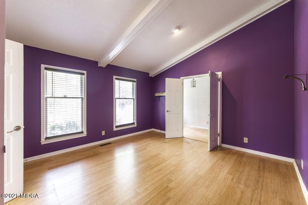 225 Beacon Hill Road Macon, GA 31210 - Photo 3 of 29 an empty room with wooden floor and windows