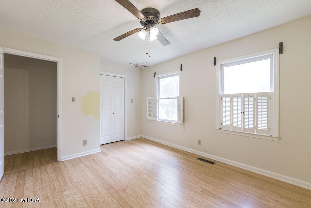 225 Beacon Hill Road Macon, GA 31210 - Photo 21 of 29 a view of an empty room with wooden floor and a window