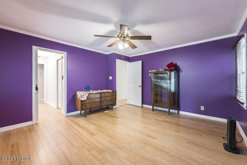 225 Beacon Hill Road Macon, GA 31210 - Photo 23 of 29 a bed room with a bed and a chandelier