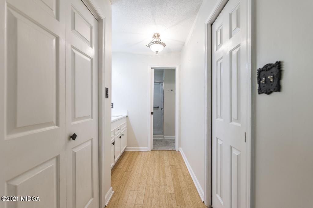 225 Beacon Hill Road Macon, GA 31210 - Photo 24 of 29 a view of a hallway with wooden floor and staircase