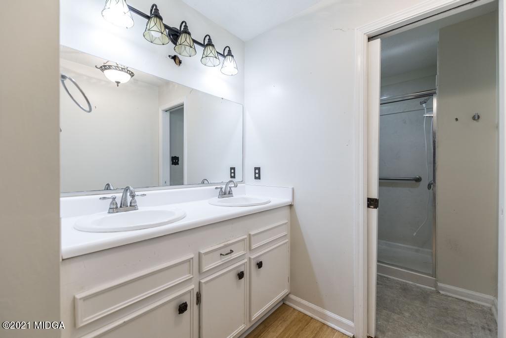 225 Beacon Hill Road Macon, GA 31210 - Photo 25 of 29 a bathroom with a sink vanity granite and a mirror