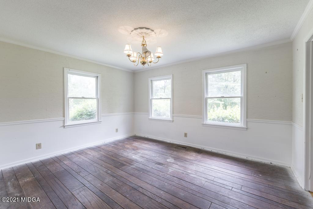 225 Beacon Hill Road Macon, GA 31210 - Photo 4 of 29 a view of an empty room with wooden floor and a window