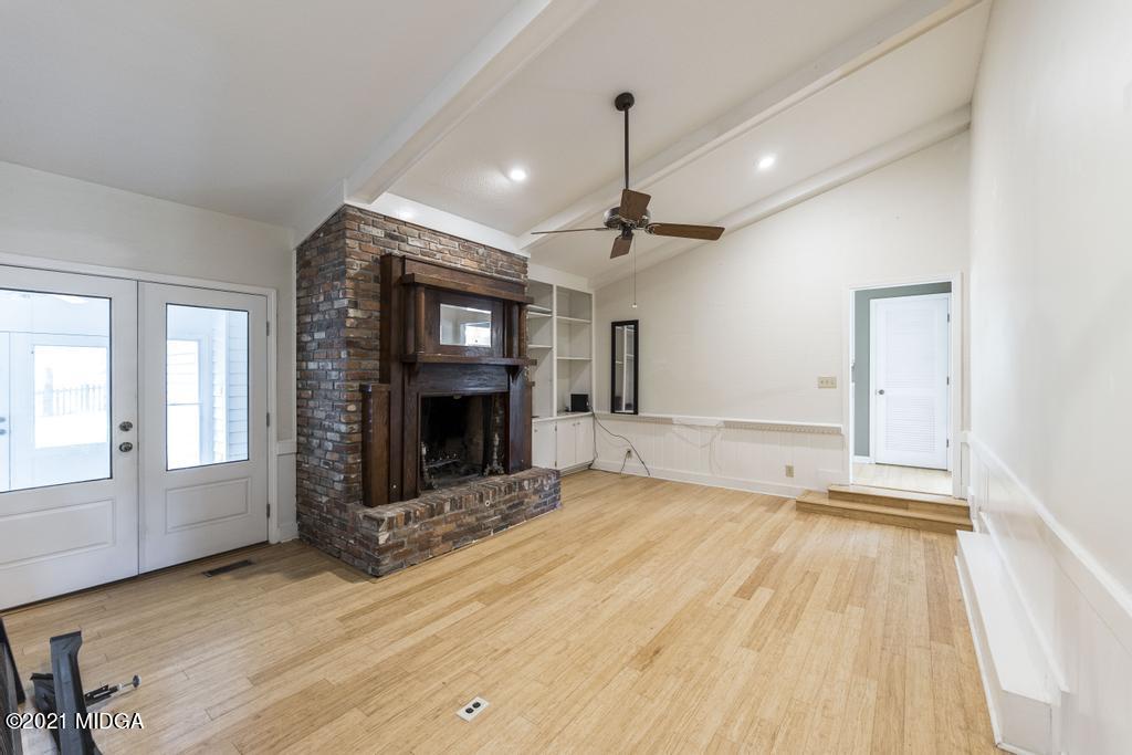 225 Beacon Hill Road Macon, GA 31210 - Photo 5 of 29 a view of an empty room with a fireplace and a window
