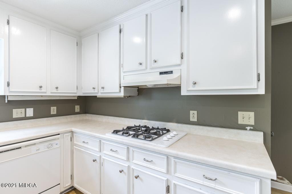 225 Beacon Hill Road Macon, GA 31210 - Photo 9 of 29 a kitchen with white cabinets and appliances