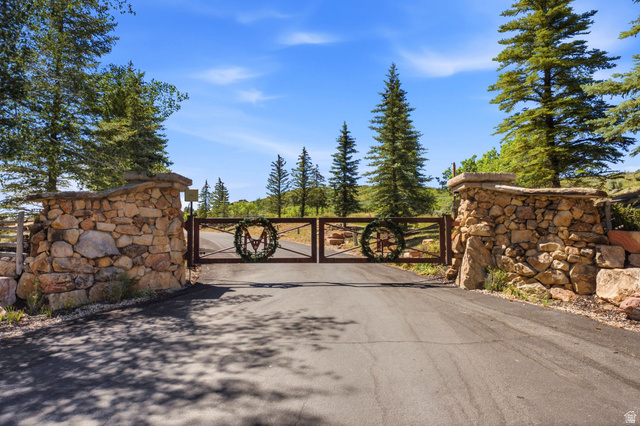 5971 Maple Ridge Trail Oakley, UT 84055 - Photo 43 of 43 Paved driveway leading to a gated entrance with stone pillar supports