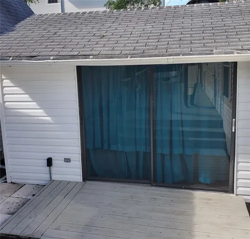 a kitchen with a sink cabinets and a wooden floor