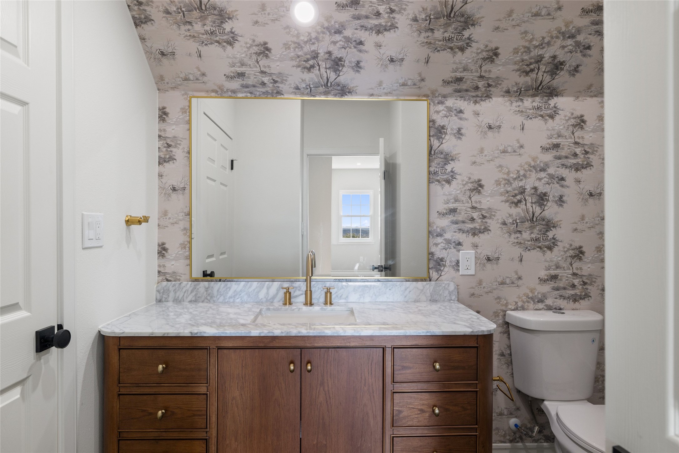 601 Hays Country Acres Road Dripping Springs, TX 78620 - Photo 29 of 38 An elegant wood vanity with stone counters anchors this beautifully papered bathroom.